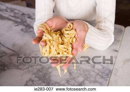 Woman holding pasta View Large Photo Image Stock Photo - Woman holding pasta. Fotosearch