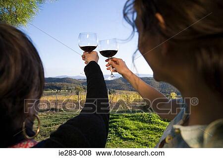 Women raising wine glasses View Large Photo Image Stock Photo - Women raising wine glasses. Fotosearch