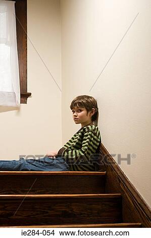 A boy sat on stairs View Large Photo Image Picture - A boy sat on stairs. Fotosearch