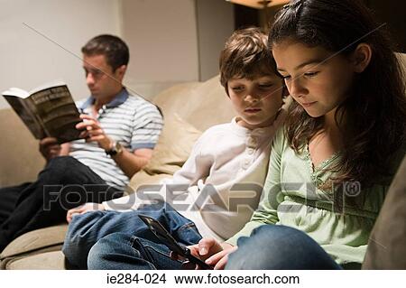 A family sat in alounge View Large Photo Image Picture - A family sat in alounge. Fotosearch