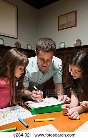 Stock Image - A father and daughter drawing. Fotosearch