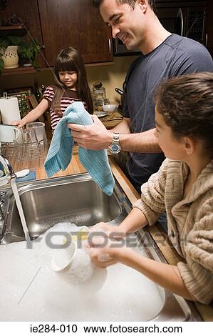 A father and his daughters washing up View Large Photo Image Stock Image - A father and his daughters washing up. Fotosearch