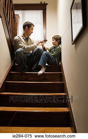 A father and son playing a game View Large Photo Image Stock Photography - A father and son playing a game. Fotosearch