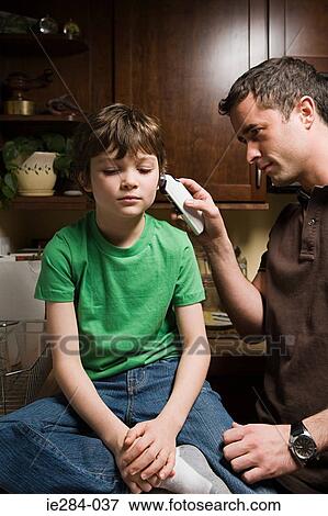 Stock Photo - A father checking his sons temperature. Fotosearch