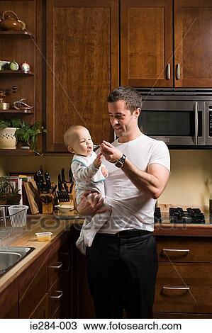 A father feeding his baby View Large Photo Image Stock Image - A father feeding his baby. Fotosearch