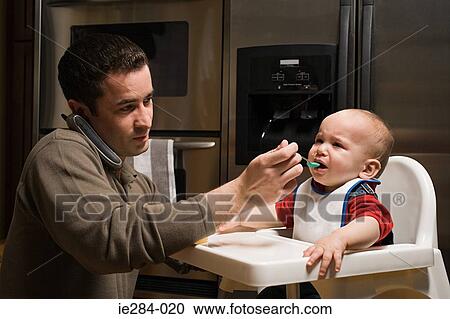 A father feeding his baby View Large Photo Image Stock Image - A father feeding his baby. Fotosearch