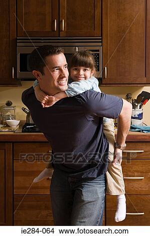 A father giving her daughter a piggyback View Large Photo Image Picture - A father giving her daughter a piggyback. Fotosearch