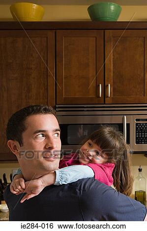 A father giving her daughter a piggyback View Large Photo Image Stock Photograph - A father giving her daughter a piggyback. Fotosearch