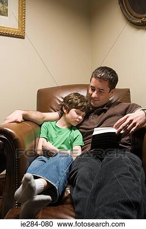 Stock Image - A father looking at his sleeping boy. Fotosearch