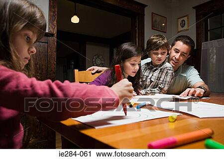 A father supervising his children with their homework View Large Photo Image Stock Image - A father supervising his children with their homework. Fotosearch