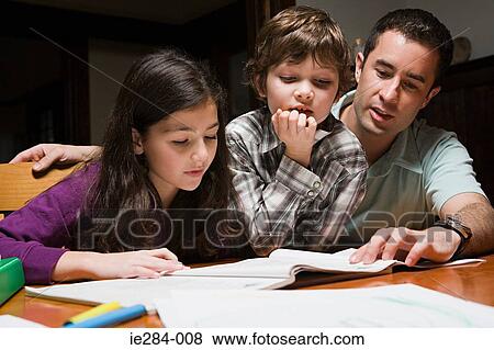 A father supervising his children with their homework View Large Photo Image Stock Photo - A father supervising his children with their homework. Fotosearch