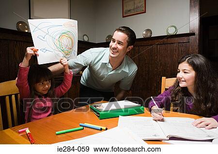 A father supervising his children with their homework View Large Photo Image Stock Photo - A father supervising his children with their homework. Fotosearch