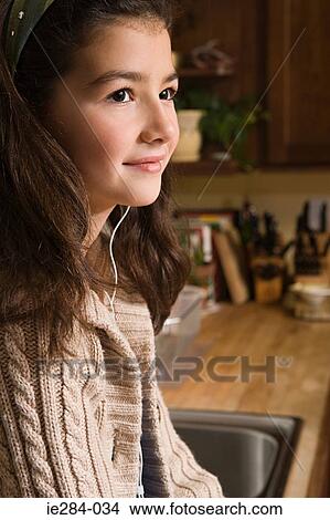 A girl listening to an mp3 player View Large Photo Image Picture - A girl listening to an mp3 player. Fotosearch