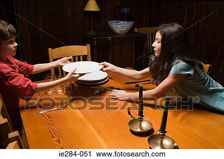 Brother and sister arranging a table View Large Photo Image Stock Image - Brother and sister arranging a table. Fotosearch