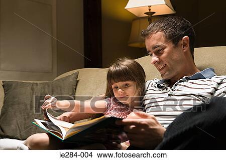 Picture - Father and daughter reading a book. Fotosearch