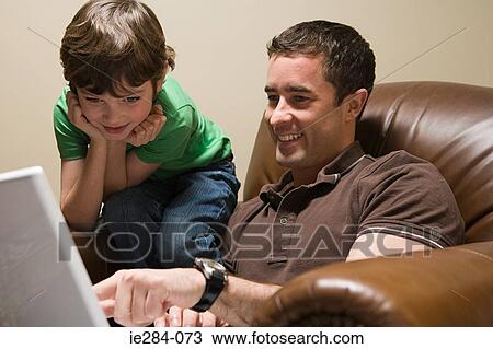 Father and son with a laptop View Large Photo Image Stock Image - Father and son with a laptop. Fotosearch