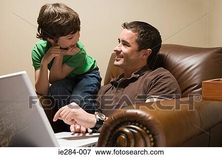Father and son with a laptop View Large Photo Image Stock Photo - Father and son with a laptop. Fotosearch