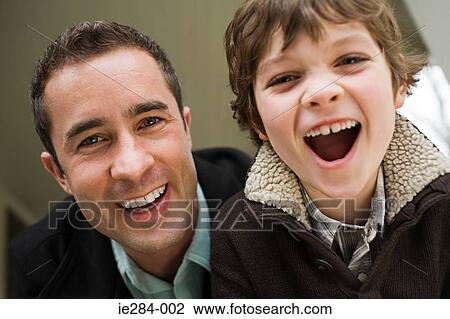 Stock Image - Portrait of a father and son laughing. Fotosearch
