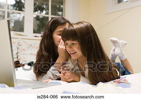 Sisters whispering View Large Photo Image Stock Photograph - Sisters whispering. Fotosearch
