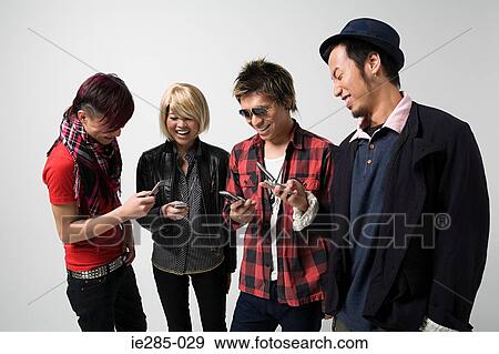 Stock Photo - Four friends text messaging. Fotosearch