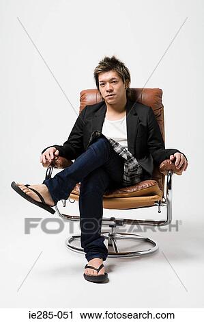 Japanese man sitting on a leather armchair View Large Photo Image Stock Image - Japanese man sitting on a leather armchair. Fotosearch