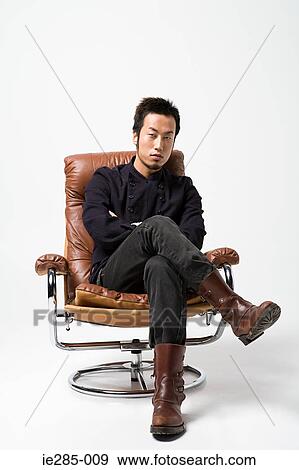 Japanese man sitting on a leather armchair View Large Photo Image Stock Photo - Japanese man sitting on a leather armchair. Fotosearch
