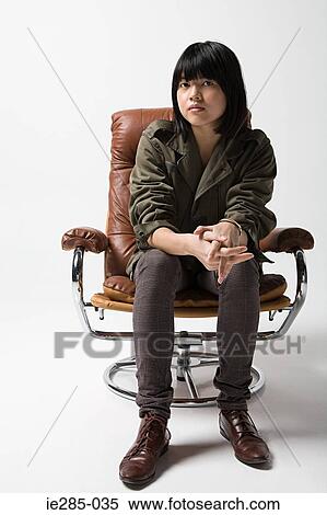 Japanese woman sitting on a leather armchair View Large Photo Image Stock Photography - Japanese woman sitting on a leather armchair. Fotosearch