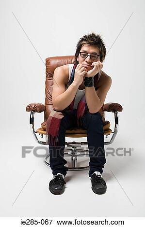 Thoughtful looking young man View Large Photo Image Stock Photo - Thoughtful looking young man. Fotosearch