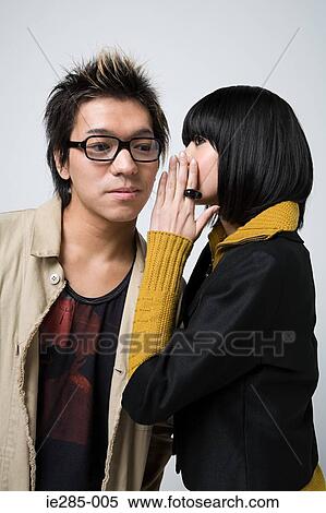 Young couple whispering View Large Photo Image Stock Photography - Young couple whispering. Fotosearch