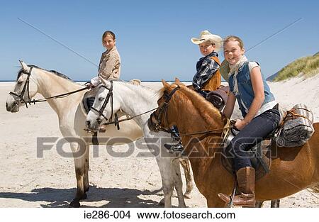 A boy and girls riding horses View Large Photo Image Picture - A boy and girls riding horses. Fotosearch