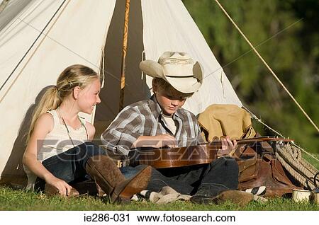 A boy playing a guitar View Large Photo Image Stock Image - A boy playing a guitar. Fotosearch