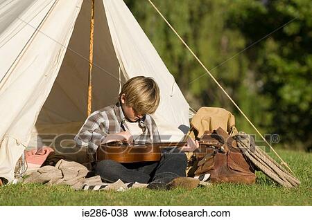 Stock Photo - A boy playing a guitar. Fotosearch