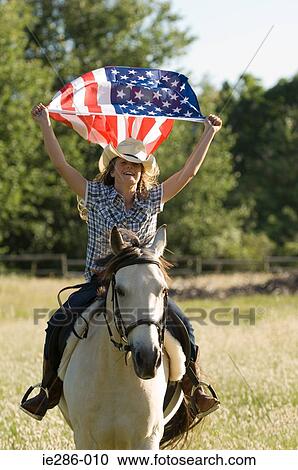 Stock Image - A girl holding the american flag. Fotosearch
