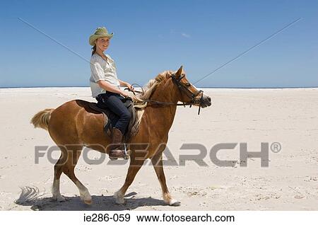 A girl riding a horse View Large Photo Image Stock Photo - A girl riding a horse. Fotosearch