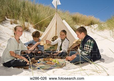 Stock Photograph - Friends having a picnic. Fotosearch