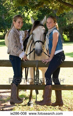 Portrait of two girls and a horse View Large Photo Image Stock Photo - Portrait of two girls and a horse. Fotosearch