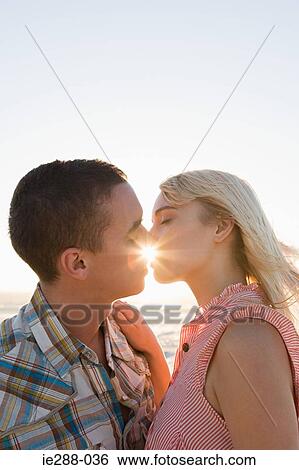 Stock Photograph - A couple kissing. Fotosearch