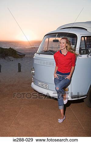 A woman leaning against a camper van View Large Photo Image Stock Photo - A woman leaning against a camper van. Fotosearch