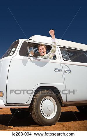 A young man driving a camper van View Large Photo Image Picture - A young man driving a camper van. Fotosearch