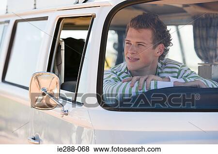 A young man in a camper van View Large Photo Image Stock Photo - A young man in a camper van. Fotosearch