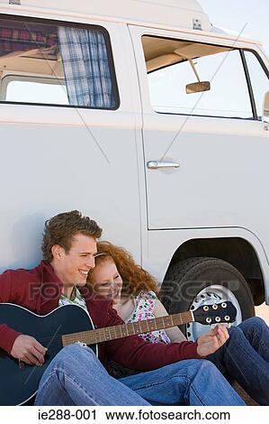 A young man tuning his guitar View Large Photo Image Stock Image - A young man tuning his guitar. Fotosearch