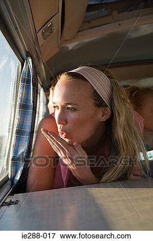 A young woman blowing a kiss View Large Photo Image Stock Photo - A young woman blowing a kiss. Fotosearch
