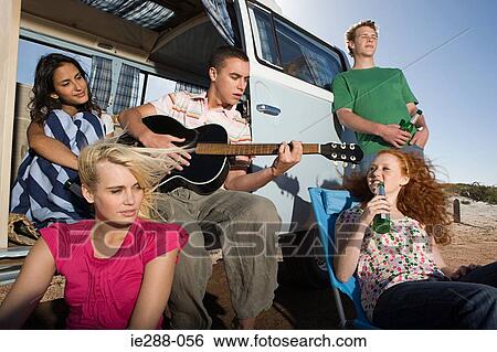 Friends and a camper van View Large Photo Image Stock Photograph - Friends and a camper van. Fotosearch