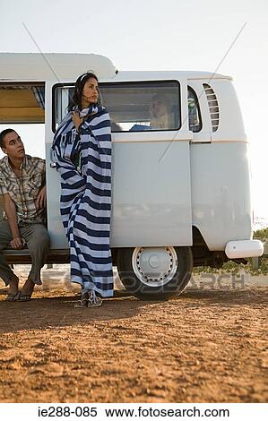 Stock Photography - Friends and a camper van. Fotosearch