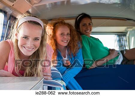 Stock Image - Friends in a camper van. Fotosearch