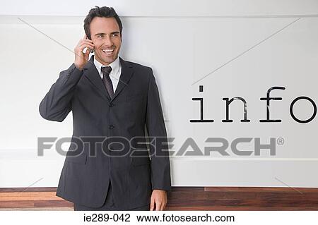 Businessman by information sign View Large Photo Image Stock Image - Businessman by information sign. Fotosearch