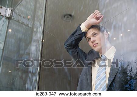 Businessman leaning on window View Large Photo Image Stock Photo - Businessman leaning on window. Fotosearch