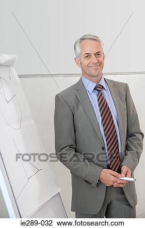 Businessman with flipchart View Large Photo Image Stock Image - Businessman with flipchart. Fotosearch