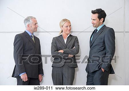 Stock Image - Colleagues having discussion. Fotosearch