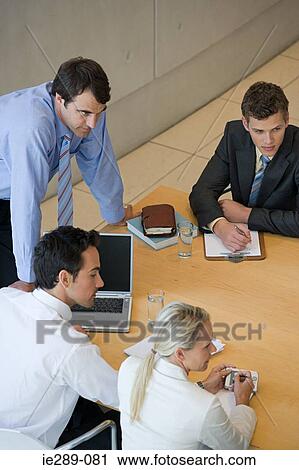 Stock Image - Colleagues in meeting. Fotosearch